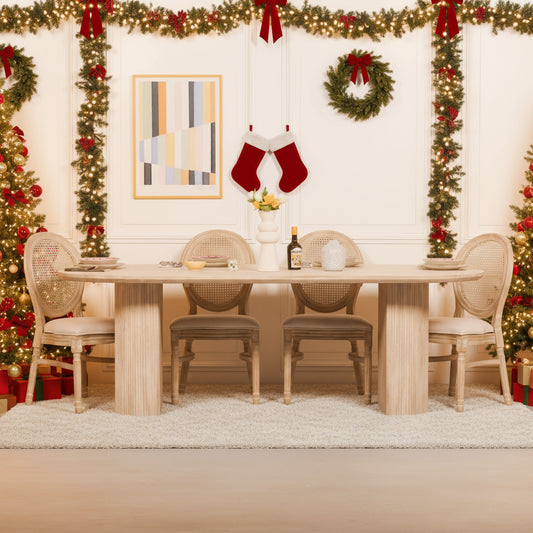 Dining room with a wooden table and chairs against a white paneled wall.