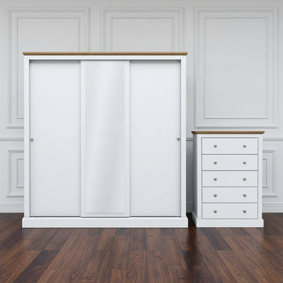 White wardrobe with sliding doors and a matching chest of drawers on a white background